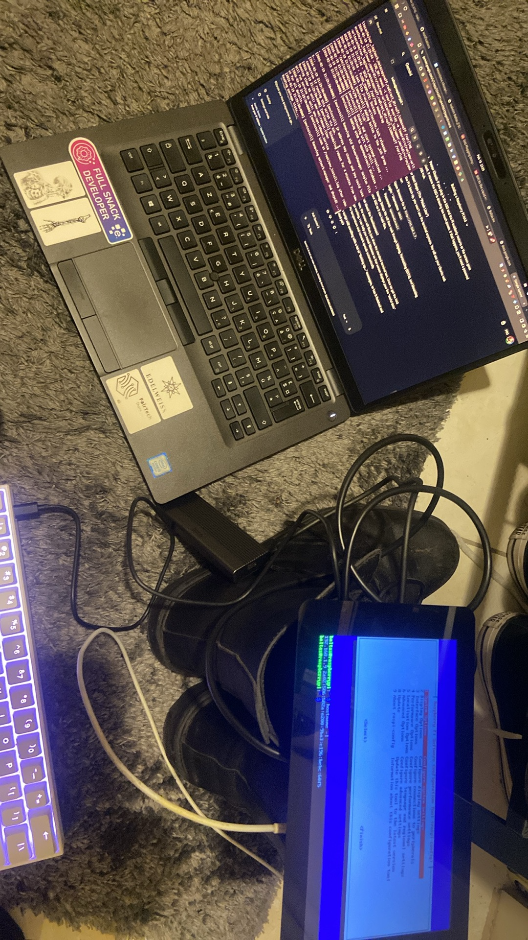 Laptop terminal with SSH session output next to a small screen showing the raspi-config menu